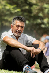 Handsome man with white beard in the park with facial expression, green, Adult