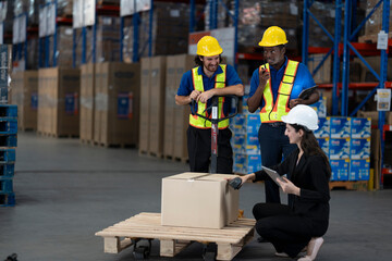 Fototapeta premium A team of engineers inspects the warehouse in a large storage warehouse. The inspection team uses electronic equipment to monitor the stored goods. staff are in safe working clothes in clean factory.