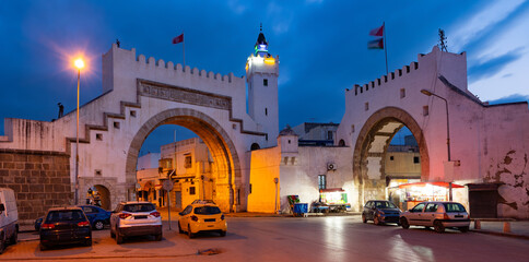 Evocative evening shot of Bab El Khadra, medieval city gate in Tunis, illuminated under...