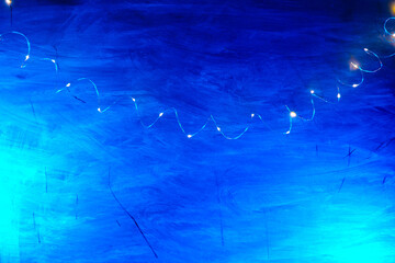  Twinkling Lights Blue Background.Christmas Shining texture. lights of garlands on a blue background.Background with Fairy Lights.Golden lights of garlands