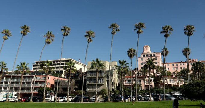 Palm trees frame the buildings of downtown La Jolla, San Diego, California, USA.
