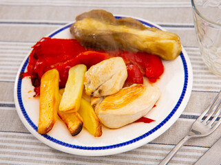 Delicious chicken breast with baked potatoes and vegetables