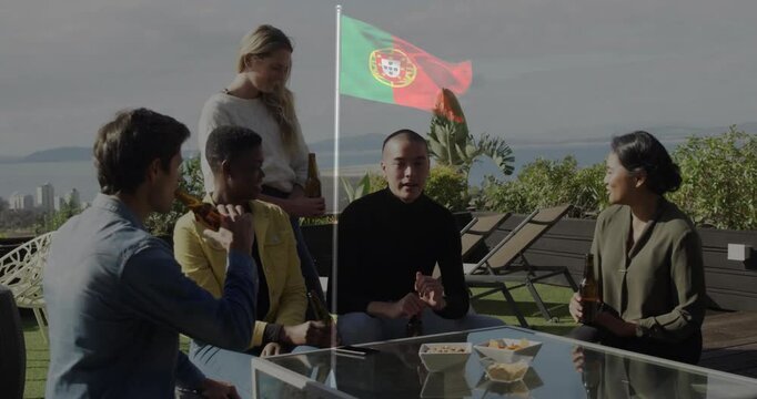 On rooftop, friends holding drinks with Portugal flag, sharing snacks and laughter