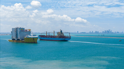 Big Construction on ship. Tender Drilling Oil Rig on Barge Ship transportation Rid to Oil Rig in The Middle of The Ocean. Five Tug boat pulling Construction