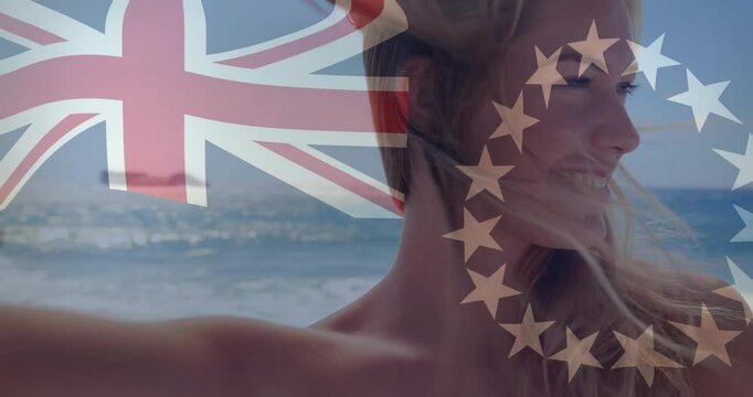 At beach, animation of Union Jack and EU flag overlaying person with windblown hair