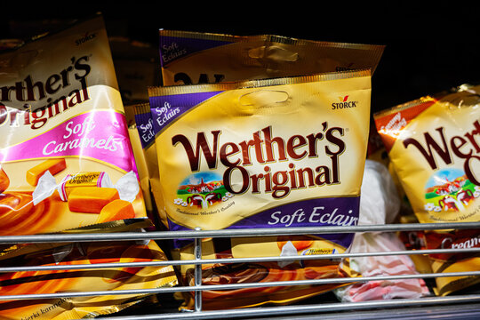 Closeup of Werther's Original soft caramels and eclairs in packaging on display