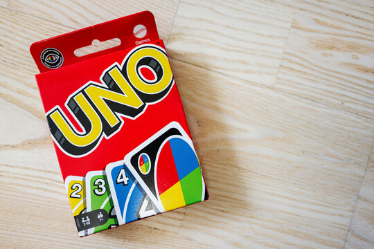 Colorful Uno card game box placed on light wooden surface
