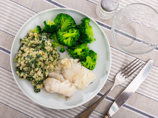Delicious dish of cod fillet, pearl barley and stewed broccoli