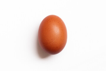 Brown egg with soft shadow isolated on white background. Concept of minimalism.