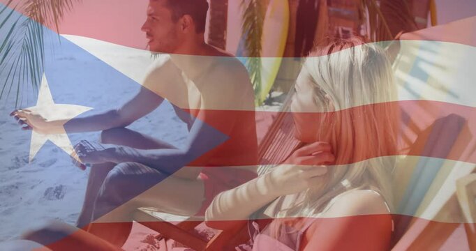 On beach, couple relaxing with Puerto Rican flag animation overlaying scene