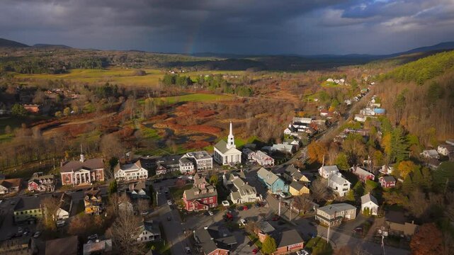 Immerse yourself in the stunning and breathtaking beauty of the vibrant autumn foliage that paints the landscape in Stowe, Vermont, showcased through this mesmerizing aerial drone video experience