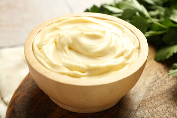 Delicious mayonnaise sauce in bowl on table, closeup