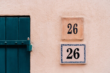 Obraz premium Rustic architecture with number 26 on wall for vintage design inspiration.