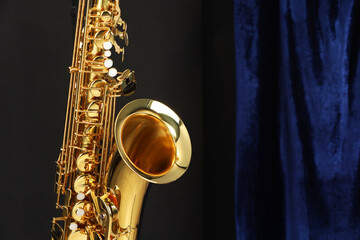 Jazz. One beautiful saxophone on color background, closeup. Space for text