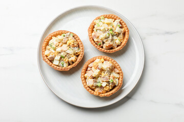 Tartlets with delicious filling on white marble table, top view