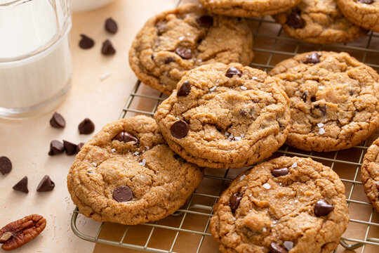 Chocolate chip cookies with pecan nuts, freshly baked cookies on a cooling rack
