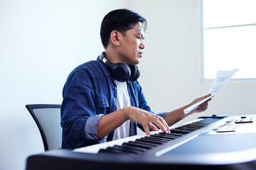 Young Pianist Enjoying The Playing On The Electric Piano