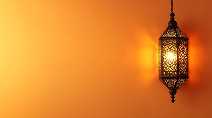 An ornate lantern hangs against a warm and radiant orange wall