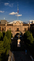 Vertical frontal aerial view of the Legislative Palace of the State of Mexico with city in the...