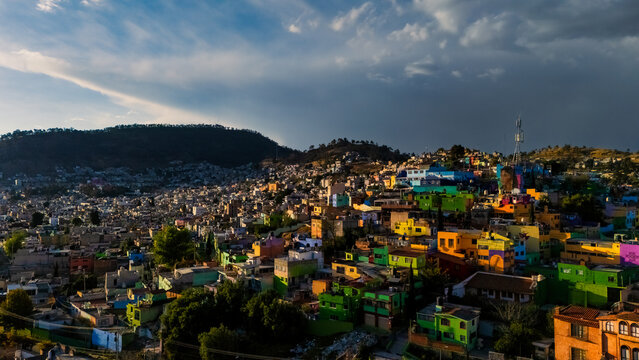 Colorful houses at sunset on the side of a hill in Toluca, Mexico