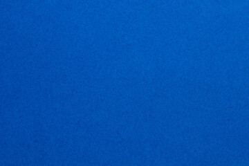 A blue background with a pattern of small squares, textured origami paper backdrop