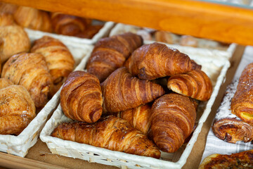 Showcase of traditional Spanish bakery shop with appetizing croissants