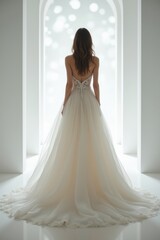 Fototapeta premium Elegant bride in luxurious wedding gown standing in bright white modern venue, romantic bridal fashion concept, back view of woman in flowing dress, dreamy wedding scene