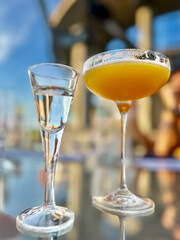 Alcohol cocktail drink French Blonde in a martini glass on the table in the restaurant outdoors.