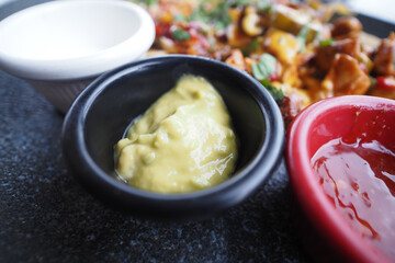 Tasty guacamole and salsa served with Mexican dish in restaurant