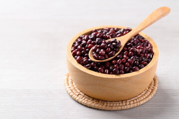 Red kidney beans in wooden bowl with spoon on white background, Food ingredient
