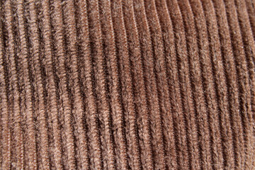 Brown corduroy fabric material close-up abstract textured background