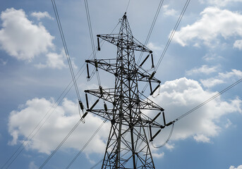 High Voltage Power Transmission Tower Against a Cloudy Sky Electricity Infrastructure Energy Grid
