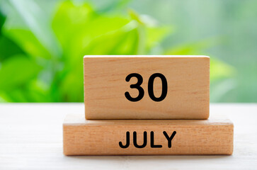 July 30th calendar text on wooden blocks with customizable space for text. Calendar concept.