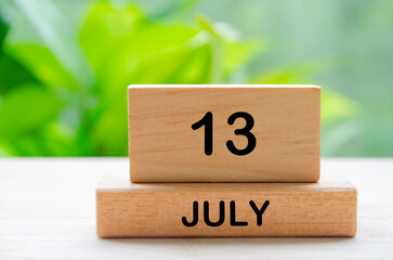 July 13th calendar text on wooden blocks with customizable space for text. Calendar concept.