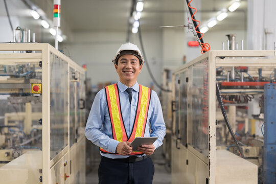 Male engineer, Industry factory, Storage warehouse. Asian male plant engineer working with digital tablet control or check operation of production system at industry factory