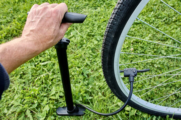 Using bicycle hand floor pump with dual nozzle adapter for schrader and presta valve.
