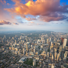 Fototapeta premium Stunning helicopter view of Toronto skyline glowing at sunset over Lake Ontario