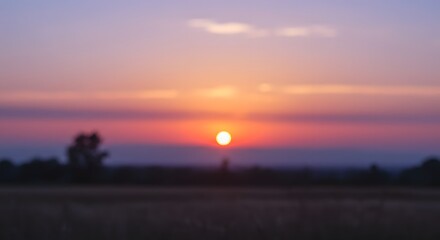 mid rise A stunning blurred sunset with the sun setting over a horizon with vibrant colors, ideal for travel or real estate.