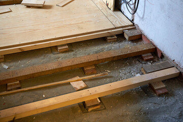 Construction work on wooden flooring in a residential space during renovation