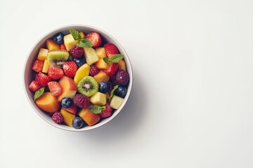 Colorful fruit salad in a bowl.  A vibrant mix of diced fruits, including strawberries, raspberries, blueberries, kiwi, and melon, is presented in a white bowl against a plain white background. 