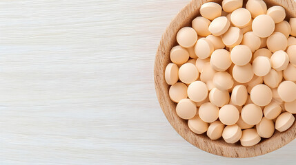 Close-Up Shot of Wooden Bowl Filled with Round Yellow Tablets