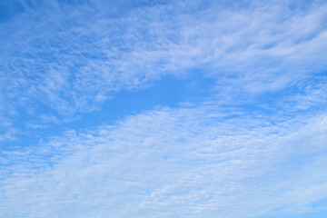 Obraz premium Photo of blue sky with clouds in the morning or evening is used as natural background texture in decorative art work.