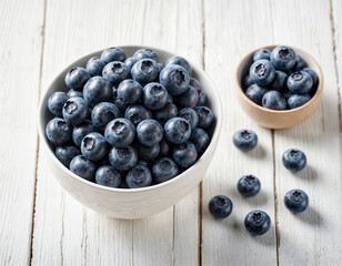 Blueberry fruits. Group of fresh organic blueberries in a bowl on a white wooden table. Healthy and vegetarian food. Directly above. Copy space.