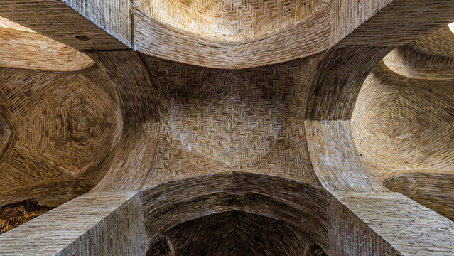 Vaulted brick ceiling of a prayer hall in the historic Jameh Mosque of Isfahan, Iran – ancient Islamic architecture and intricate geometric brickwork patterns - Powered by Adobe
