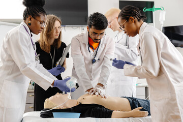 Doctors practicing cardiopulmonary resuscitation on a medical manikin