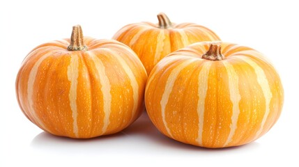 Three Fresh Orange Pumpkins With Striped Patterns on a White Background Celebrating Autumn Harvest