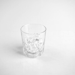 Glass with Ice Cubes on White Background.