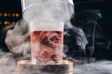  A delicious smoke Negroni cocktail in a smoking glass