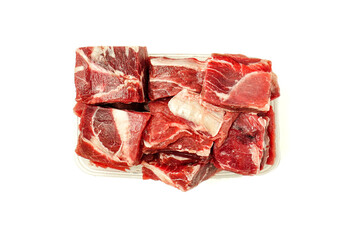Obraz premium Fresh raw beef meat in a plastic container, isolated on a light background. Ideal for cooking, meal preparation, Eid celebrations, and traditional recipes.