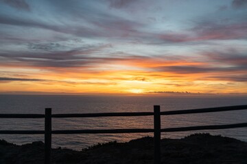 Fototapeta premium Viewpoint at Cabo Roca. Western cape of mainland Portugal. Sunset and the Atlantic Ocean. Suitable for wallpaper or screensavers